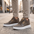 Man wearing STATURE Zenith tan leather height increasing sneakers
